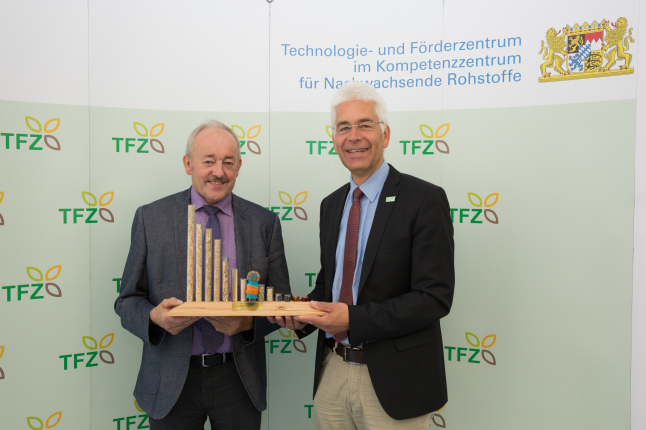 Dr. Widmann überreicht Franz Kustner eine TFZ-Brennstofforgel